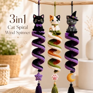 May include: Three crocheted cat spiral wind spinners hanging from a branch. The first is a black cat with a purple star, the second a calico cat with a paw print, and the third a grey cat in a witch hat with a yellow moon. Text reads 3in1 Cat Spiral Wind Spinner.