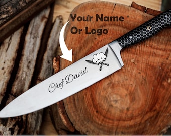 May include: A stainless steel chef knife with a black handle featuring a white honeycomb pattern. The blade is engraved with the text Chef David, a graphic of a chef hat, and a white arrow pointing to the text Your Name Or Logo.