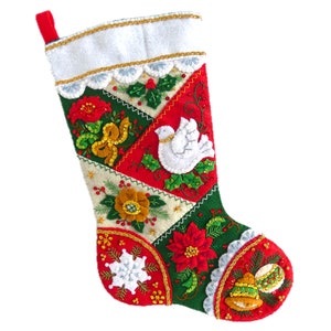 May include: A red and green Christmas stocking with a white dove, flowers, and bells embroidered on it.