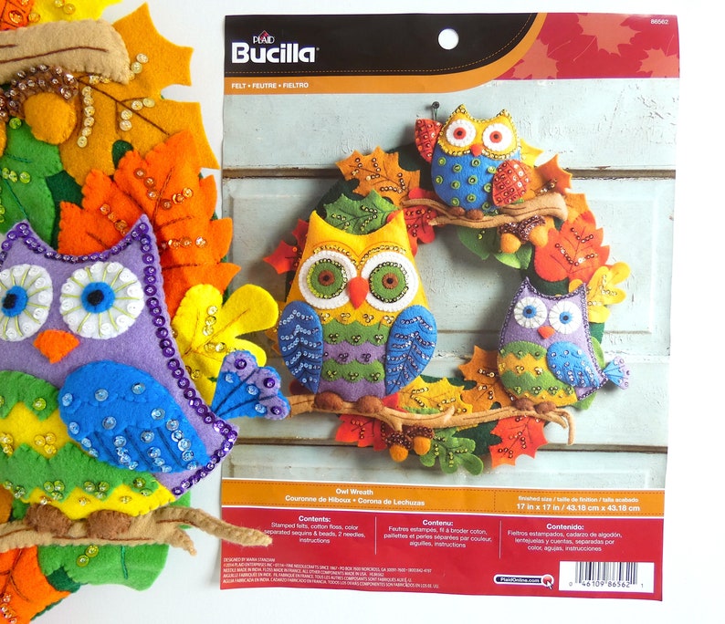 May include: A felt craft kit to make an owl wreath. The kit includes felt pieces, beads, and instructions. The finished wreath is 17 inches by 17 inches.