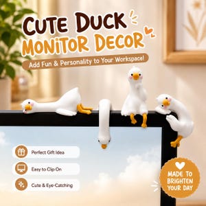 May include: Four white duck figurines with orange beaks and feet perched on the top edge of a black computer monitor. The text CUTE DUCK MONITOR DECOR is displayed above the ducks, with additional text labels including Perfect Gift Idea.