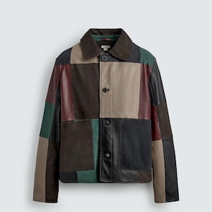 May include: A long-sleeve jacket featuring a patchwork design of leather and suede panels in shades of dark brown, black, beige, burgundy, and forest green. The jacket includes a pointed collar, a front button closure, and two large front pockets.