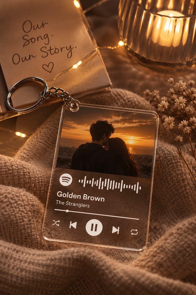 May include: A clear acrylic square keyring featuring a printed photograph of a couple at sunset. The design includes a Spotify-style music player interface with the song title Golden Brown by The Stranglers, a progress bar, and playback icons.