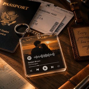 May include: A square acrylic keyring featuring a printed music player interface with a sunset photo of a couple, a sound wave graphic, and the text Golden Brown by The Stranglers, complete with playback controls and a silver metal split ring attachment.