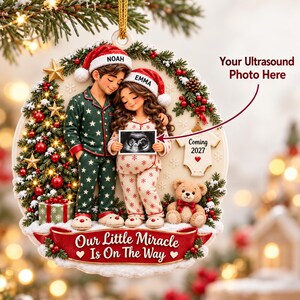 May include: A round Christmas ornament featuring a couple in pyjamas with Santa hats labelled Noah and Emma, holding an ultrasound photo. It includes a decorated tree, a teddy bear, a baby onesie labelled Coming 2027, and the text Our Little Miracle Is On The Way.