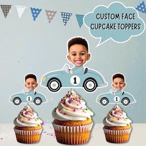 May include: Custom face cupcake toppers featuring a cartoon illustration of a child's face on a light blue race car with the number one. The toppers are displayed above three cupcakes with white frosting and colourful sprinkles. Text reads CUSTOM FACE CUPCAKE TOPPERS.