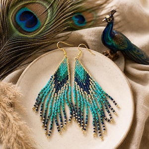 Pendientes largos con flecos de perlas en color turquesa, azul marino y dorado. Joyería tejida a mano.