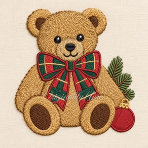 May include: An embroidered golden brown teddy bear featuring a large plaid bow in red, green, and gold. The bear has dark brown circular patches on its feet, a black nose, and black eyes. Beside the bear are green pine needles and a red ornament.
