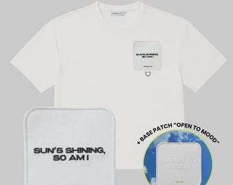 May include: A white short-sleeved t-shirt featuring a square patch on the chest with the text SUN'S SHINING, SO AM I. An additional square patch is shown separately with the same text, and a circular inset displays a patch reading OPEN TO MOOD.