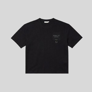 May include: A black short-sleeved t-shirt featuring a crew neckline and a square patch pocket on the left chest. The patch is black with the text OPEN TO MOOD printed in a dark grey font and includes a small silver metal ring attached at the bottom.
