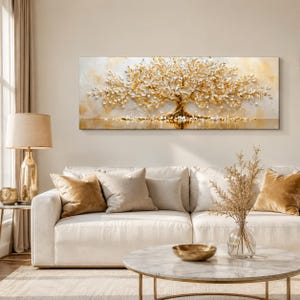 May include: A rectangular wall art piece featuring a textured, three-dimensional tree with white and gold leaves. The tree is centred against a soft, cream-coloured background with golden highlights, creating a luminous effect across the canvas.