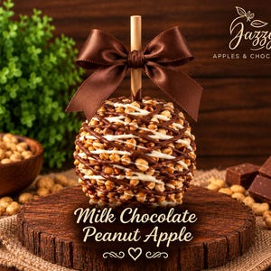 May include: A caramel apple coated in chopped peanuts and drizzled with milk and white chocolate, topped with a brown satin ribbon on a wooden stick. The text reads Jazzy APPLES & CHOCOLATES and Milk Chocolate Peanut Apple.