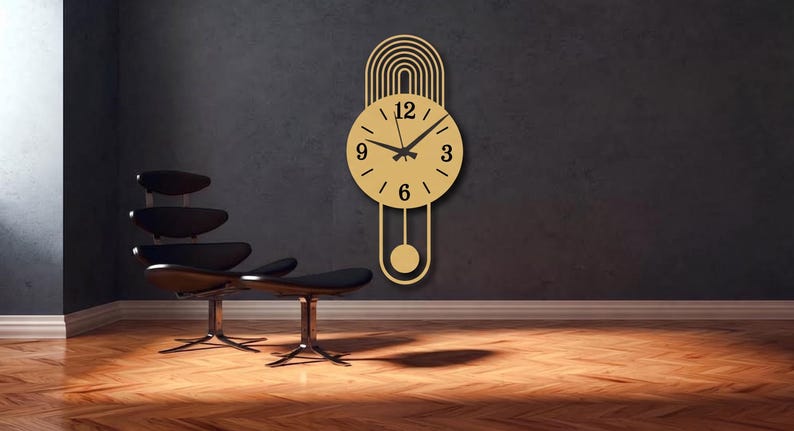 May include: A gold-colored wall clock with a circular face, black hands, and black numerals at the 3, 6, 9, and 12 positions. The clock features an arched top design with concentric lines and a pendulum extending from the bottom of the circle.