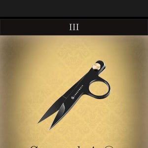 May include: Black metal thread nippers featuring a gold-toned pivot screw and the brand name Guggenheim printed in white on the blade. The tool has a single finger loop and sharp, pointed blades designed for precision cutting of threads.