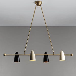 May include: A linear pendant light fitting featuring a horizontal brass rod suspended by two angled brass arms. The fitting holds four cone-shaped shades in alternating black and off-white colours, each pointing downwards along the central bar.