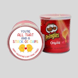 May include: A red and white Pringles can with a Valentine's Day sticker that says "You're all that and a stack of chips. Happy Valentine's Day from James". The sticker features two cartoon chips with hearts.