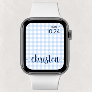 May include: A smart watch with a white band and a black bezel. The watch face displays a light blue gingham pattern, the name "christen" in a cursive font, and the date and time.