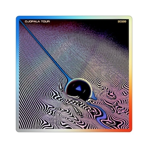 May include: A square sticker featuring the text DJOPALA TOUR 2026. The graphic displays a dark sphere centred amidst swirling, distorted black and white lines that transition into purple and blue hues, framed by a vibrant rainbow-coloured border.