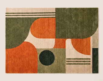 May include: A rectangular area rug featuring a geometric pattern with blocks of burnt orange, olive green, and cream. The design includes curved shapes, a solid dark green circle, and horizontal line accents across the textured surface.