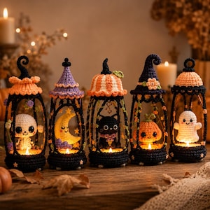May include: Five crocheted Halloween lanterns featuring black frames and colorful tops. The lanterns contain small crocheted figures: a skull, a yellow crescent moon, a black cat, an orange pumpkin, and a white ghost, each illuminated by a light.