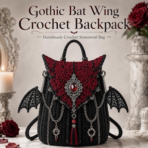 May include: A black crochet backpack featuring dark red lace detailing on the flap, bat wing side accents, and a central silver-toned brooch with a red gemstone. The bag includes silver chain embellishments and a red and black tassel.