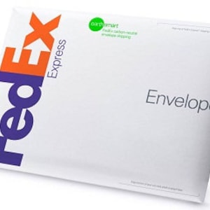 May include: White FedEx Express Envelope with the FedEx logo in purple and orange. The envelope is made of paper and has a flap that closes with an adhesive strip. The envelope is labeled "Envelope" in black text.