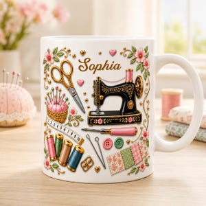 May include: A white ceramic mug featuring the name Sophia in gold script, surrounded by illustrations of sewing supplies including a black sewing machine, gold scissors, a pink pincushion, a measuring tape, colourful thread spools, and fabric.