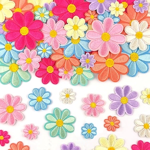 May include: A collection of embroidered flower patches in various sizes and colors, including shades of pink, blue, yellow, orange, purple, and white. Each patch features a circular yellow center surrounded by eight or more rounded petals.