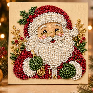 May include: A square canvas art piece featuring a mosaic of Santa Claus created with small, round, multi-colored beads. The design displays a white-bearded Santa in a red hat, accented with green holly leaves, red berries, and gold branches.