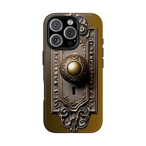 May include: A phone case featuring a detailed antique door handle design. The case has a gold and bronze color scheme, with intricate patterns and a keyhole. The camera lenses are visible at the top.