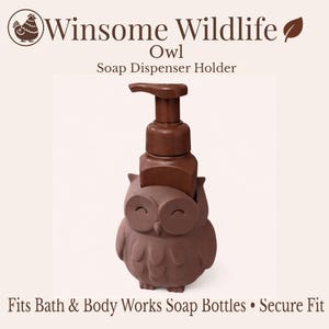 May include: A brown owl-shaped soap dispenser holder with a matching brown pump. The text "Winsome Wildlife Owl Soap Dispenser Holder" is at the top. The text "Fits Bath & Body Works Soap Bottles • Secure Fit" is at the bottom.