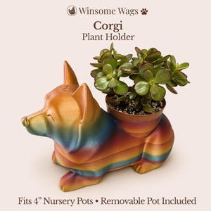 May include: A colorful corgi-shaped plant holder with a removable pot, holding a small green plant. The holder is painted with a gradient of colors, including orange, blue, and yellow. The text on the image reads "Corgi Plant Holder" and "Fits 4" Nursery Pots".