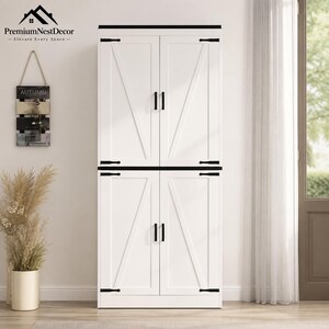 May include: A tall white storage cabinet featuring four doors with black metal handles and hinges. Each door displays a diagonal cross-brace design. The cabinet has a flat black top trim and is positioned against a plain wall.