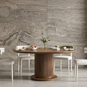 May include: A round wooden dining table with a fluted cylindrical base, surrounded by four chairs with white upholstered seats and curved backrests. A glass vase with greenery and a bowl of fruit sit on the table surface. Logo reads Premiumnestdecor.
