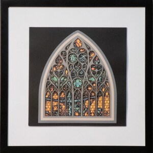 May include: A framed layered paper art piece depicting a pointed gothic arch window. The design features intricate grey cutouts layered over orange and teal backgrounds with a honeycomb pattern, all set against a black square within a white mat.