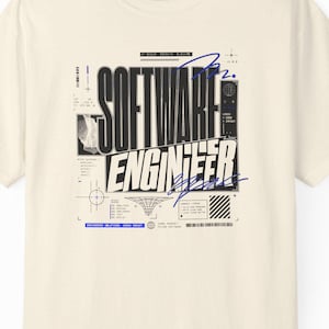May include: A cream-colored short-sleeve t-shirt featuring a black and blue graphic print on the chest. The design includes the text "SOFTWARE ENGINEER" in a bold, sans-serif font, surrounded by technical diagrams, lines, and small symbols.