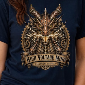 May include: A navy blue t-shirt featuring a graphic of a mechanical dragon head surrounded by gears and lightning bolts. Below the dragon, a banner displays the text "HIGH VOLTAGE MIND" and "ELECTRICAL ENGINEER" in a bold, serif font.