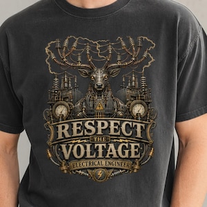 May include: A charcoal gray short-sleeve t-shirt featuring a graphic print of a mechanical deer with antlers made of electrical wires. The text reads RESPECT THE VOLTAGE ELECTRICAL ENGINEER, surrounded by industrial electrical equipment and gauges.
