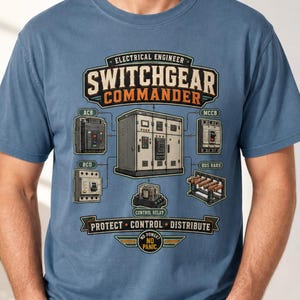 May include: A blue short-sleeve t-shirt featuring a graphic print with the text Electrical Engineer Switchgear Commander. The design includes illustrations of electrical components like an ACB, MCCB, RCD, bus bars, and a control relay.