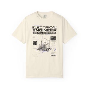 May include: A cream-coloured short-sleeve t-shirt featuring a black and blue graphic print of an electrical substation. The text reads ELECTRICAL ENGINEER DIGITAL SUBSTATION OLD POWER NEW BRAIN, accompanied by technical diagrams, data charts, and icons.