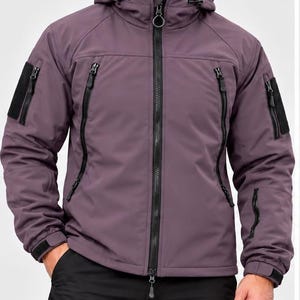 May include: A mauve hooded tactical jacket featuring a full-length black front zip, two vertical chest pockets with black zips, and black velcro patches on both sleeves. The jacket includes adjustable cuffs and a drawstring hood.