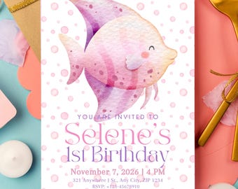 May include: A birthday invitation featuring a watercolor illustration of a pink and purple fish. The invitation includes the text "Selene's 1st Birthday" and event details. The background has a pattern of small pink circles.
