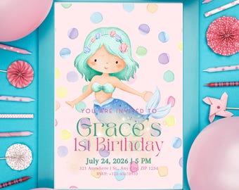 May include: A framed invitation for Grace's 1st birthday, featuring a watercolor mermaid with teal hair and a blue tail. The invitation includes the date, time, and RSVP information, set against a pink background with colorful polka dots. The frame is teal.