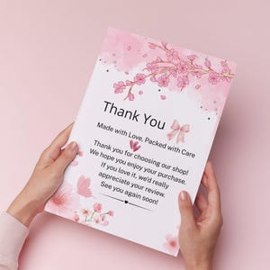 May include: A rectangular white thank you card featuring pink cherry blossom branches, a small pink bow, and a butterfly. The text reads: Thank You, Made with Love, Packed with Care, Thank you for choosing our shop! We hope you enjoy your purchase. If you love it, we'd really appreciate your review. See you again soon!