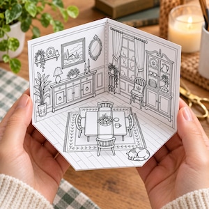 May include: A black and white line art illustration of a dining room interior printed on a folded card. The scene features a table with four chairs, a hutch, a sideboard, a window with curtains, a rug, and a sleeping cat on the floor.