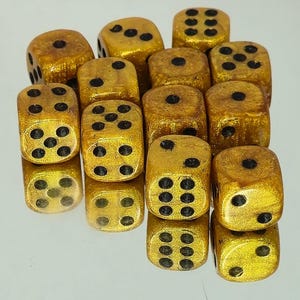 May include: A collection of twelve six-sided dice with a metallic gold finish and black pips. Each die features standard numerical arrangements from one to six, with the pips clearly indented on the shimmering, textured gold surfaces of the cubes.