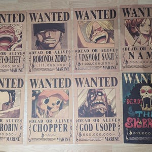 May include: A collection of eight rectangular posters featuring One Piece characters. Seven posters have a tan background with the text WANTED, DEAD OR ALIVE, and MARINE, displaying bounty amounts for Monkey D. Luffy, Roronoa Zoro, Vinsmoke Sanji, Nami, Nico Robin, Chopper, and God Usopp. One poster features a skull icon and the text THE SK BROOK.