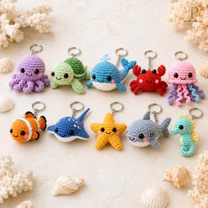 May include: A collection of ten crocheted sea creature keychains including an octopus, turtle, whale, crab, jellyfish, clownfish, stingray, starfish, shark, and seahorse. Each small stuffed animal features black bead eyes and a metal keyring.