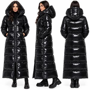 May include: A long, black, glossy puffer coat featuring a full-length front zip, a large hood, and horizontal quilted panels. The coat extends to the lower calf and is shown from the front, side, and back angles on a white background.