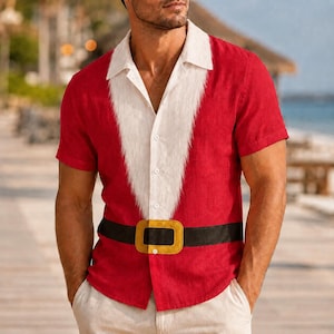 May include: A short-sleeved red button-down shirt featuring a white faux-fur trim down the front placket and a black belt graphic with a gold buckle across the waist, mimicking a Santa Claus suit design with a classic collar and button closure.